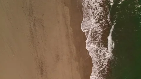 Waves crashing against an empty sand beach Stock Footage 162045663