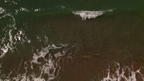 Waves crashing against an empty sand beach Stock Footage 162046030