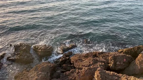 Waves crashing against an empty stone rock Stock Footage 212628865