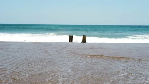 Waves Crashing Against a Old Torn Down Dock On The Sand Stock Footage 231715951
