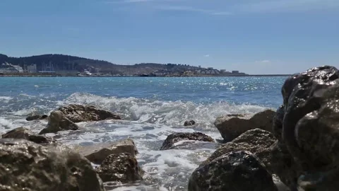 Waves crashing against the rocks on the background of the port Stock Footage 183820894