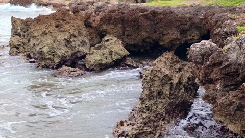 Waves crashing against rocks on a cloudy day in Oahu Hawaii Stock Footage 279909844