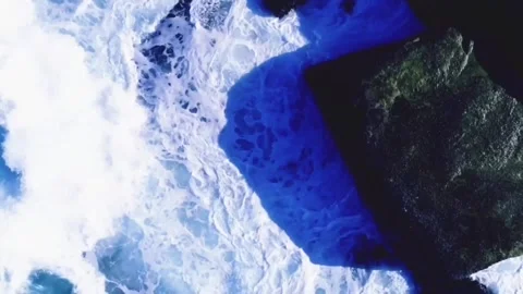 Waves crashing against the rocks drone footage Video stock 112468885