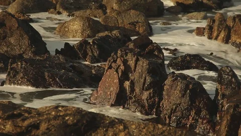 Waves crashing against rocks Stock Footage 73660357