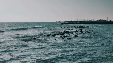 Waves crashing against rocks on a rocky beach Stock Footage 151793653