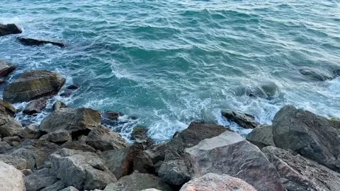 Waves crashing against rocks on a rugged coastline Stock Footage 344412445