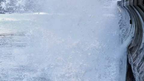 Waves crashing against a sea wall in Porto Moniz Madeira during daylight Stock Footage 321892558