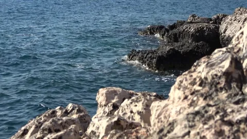 Waves crashing against sharp limestone rocks along the coast Video stock 342394322