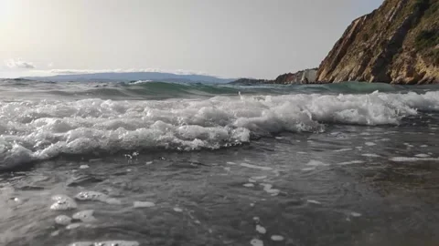 Waves crashing along the beach during the sunset, summer time. Stock Footage 161252159