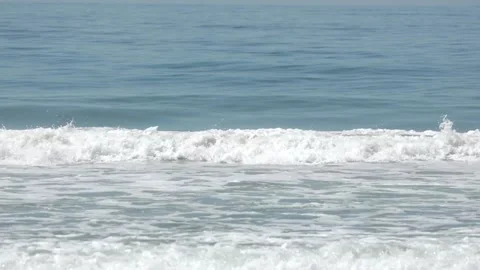Waves crashing along a beach Stock Footage 178189782