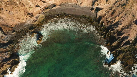 Waves crashing and foaming on empty rocky tropical black beach, volcanic Stock Footage 221130692