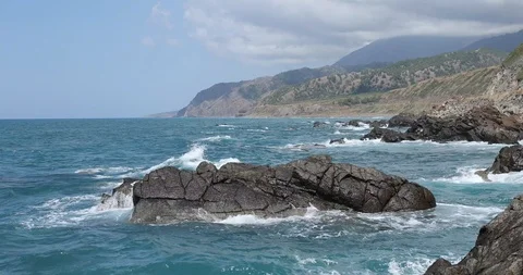 Waves crashing and hitting on the rocks at the ocean or sea. Stock Footage 101011769