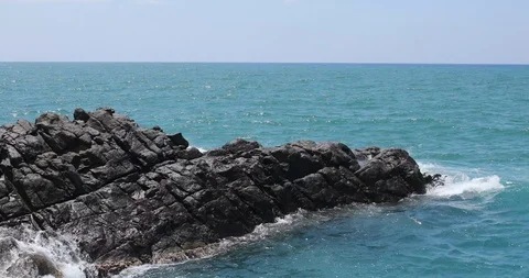 Waves crashing and hitting on the rocks at the ocean or sea. Stock Footage 101011778