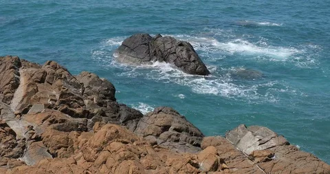 Waves crashing and hitting on the rocks at the ocean or sea. Stock Footage 101011817