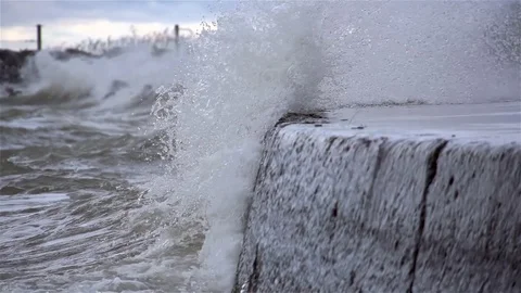 Waves crashing into barrier Stock Footage 98678870