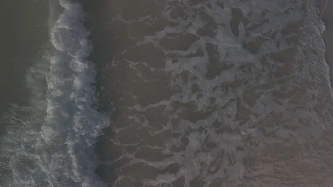 Waves Crashing on the Beach from Above Drone Video Stock Footage 261597244