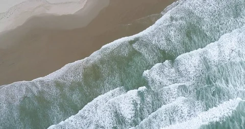 Waves Crashing on the Beach from Above Stock Footage 123908405