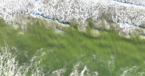 Waves crashing on the beach from above Stock Footage 247849332