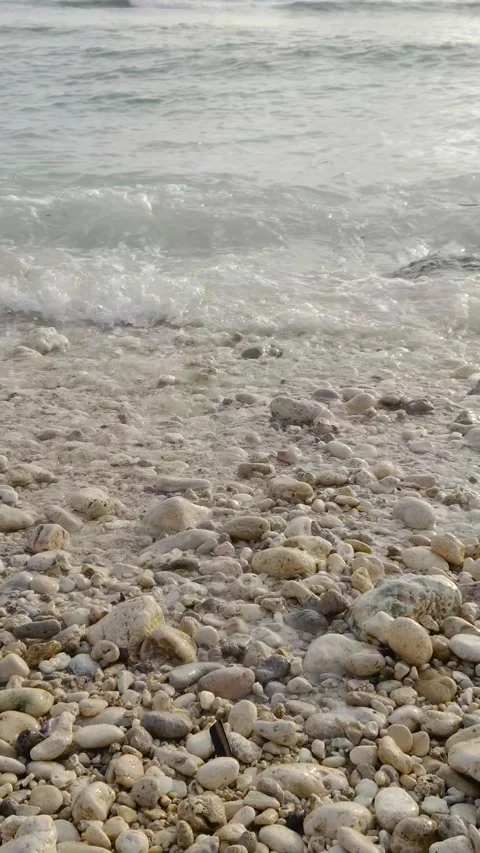 Waves crashing on the beach in the afternoon Stock Footage 274725512