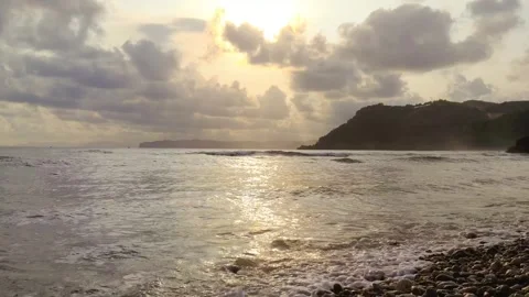 Waves crashing on the beach in the afternoon Stock Footage 274725528