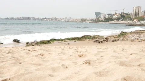 Waves crashing on a beach by the Atlantic Ocean in Cascais, Portugal. Sound on Stock Footage 126654846