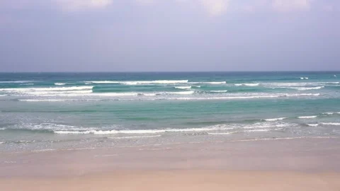 Waves crashing on a beach Stock Footage 332142304