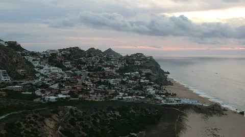Waves crashing on beach front nice mountain neighborhood Stock Footage 248477329