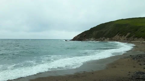 Waves crashing on the beach with pebble Stock Footage 162623896