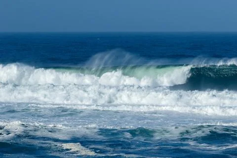 Waves crashing at the beach Stock Photos