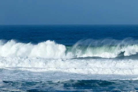 Waves crashing at the beach Stock Photos