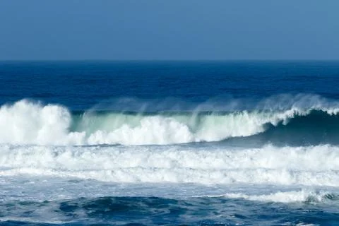Waves crashing at the beach Stock Photos
