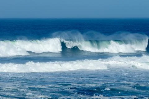 Waves crashing at the beach Stock Photos