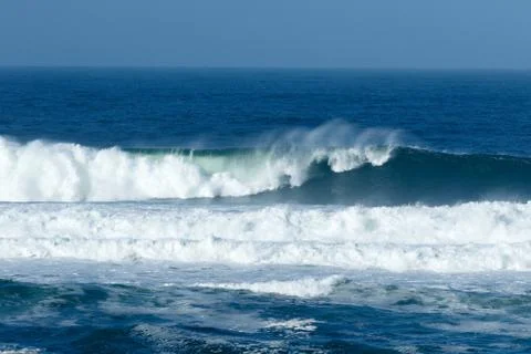 Waves crashing at the beach Stock Photos