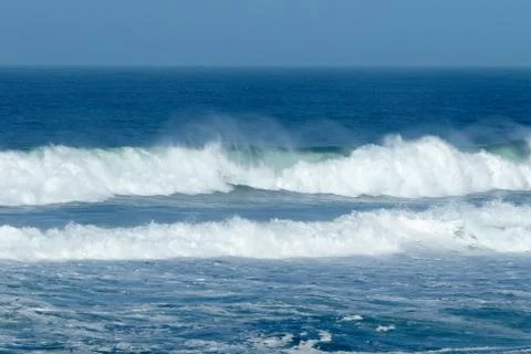 Waves crashing at the beach Stock Photos