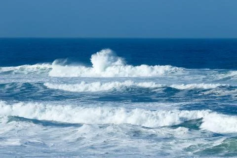 Waves crashing at the beach Stock Photos