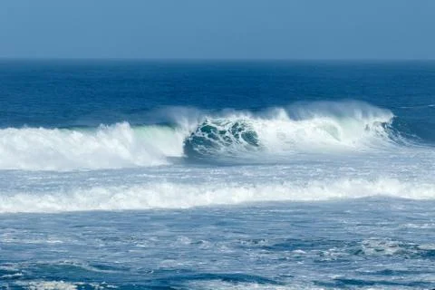 Waves crashing at the beach Stock Photos