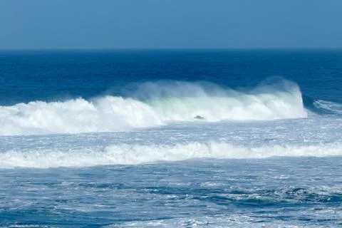 Waves crashing at the beach Stock Photos