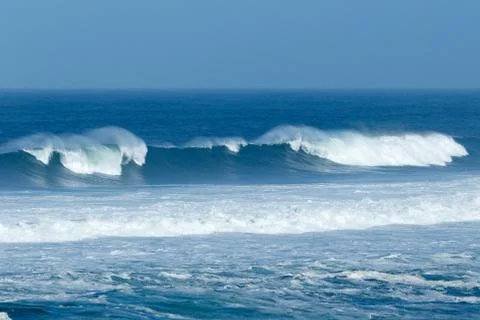 Waves crashing at the beach Stock Photos