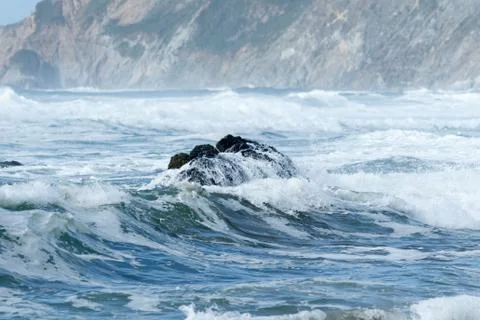 Waves crashing at the beach Stock Photos