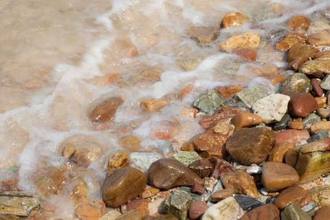 Waves crashing on a beach. Stock Photos
