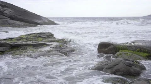 Waves Crashing on the Beach Rocks Stock Footage 239383230