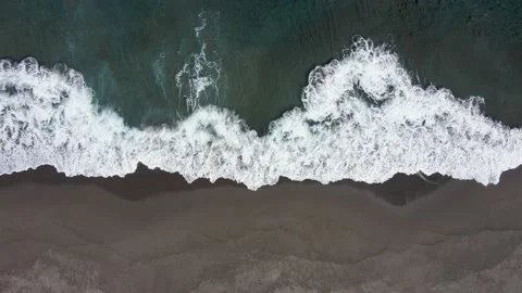 Waves crashing into the beach. Static bird's eye view. 4k drone footage Stock Footage 202278838