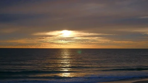 Waves crashing on a beach at sunset Stock Footage 91388486