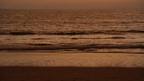 Waves crashing at beach at sunset Stock Footage 325686698