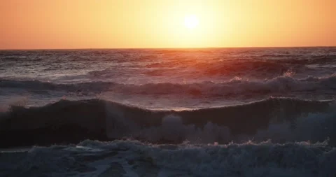 Waves Crashing On Beach At Sunset Panning 動画素材 159248780