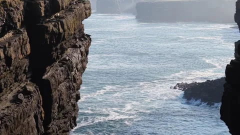 Waves Crashing Between Steep Cliffs at Loop Head, County Clare, Ireland Stock Footage 345685947