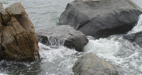 Waves crashing in big rocks Stock Footage 144983222