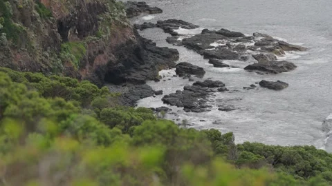 Waves crashing at the bottom of cliffs Stock Footage 295080049