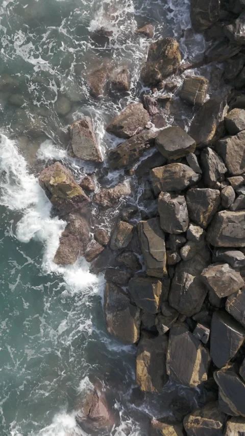 Waves crashing into breakwater Stock Footage 302394610
