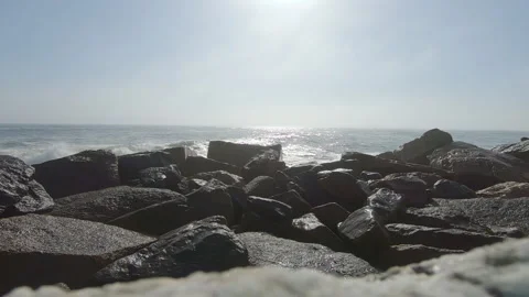 Waves crashing at the breakwater with reflections in the background. Stock Footage 193989367